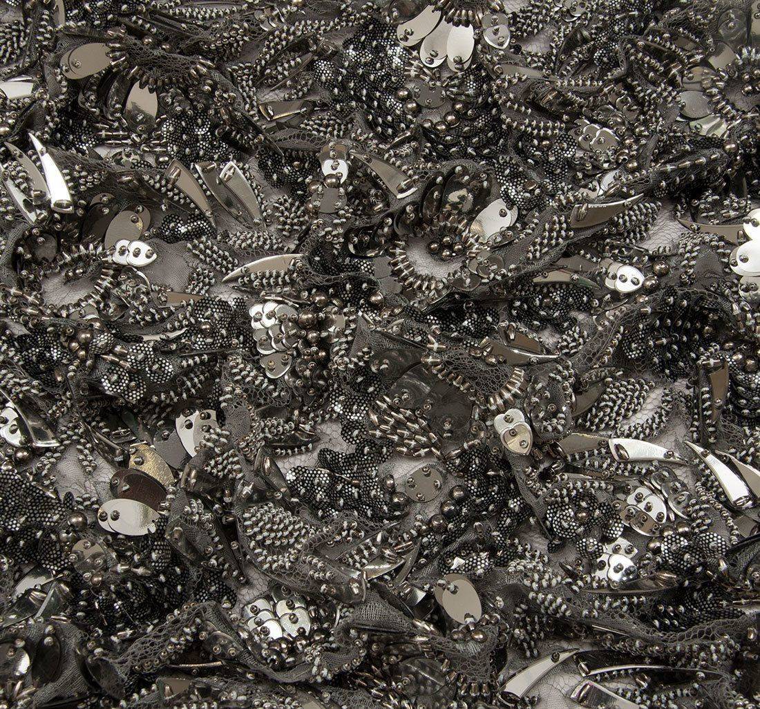 Ткань Кружево вышитое, декорированное цветами из бисера, металлизированными пайетками и фигурными элементами. Основа- кружево из искусственного шелка. Цвет основы- пепельный, цвет вышивки- оружейная сталь в наличии